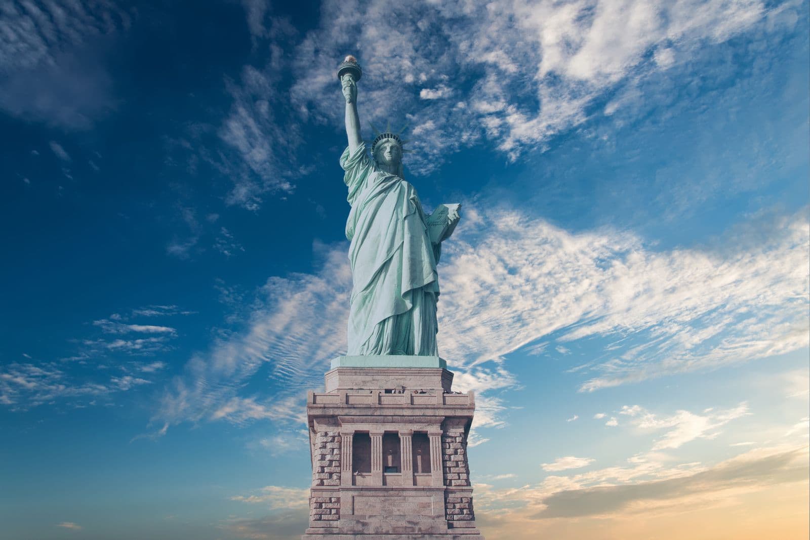 The Statue of Liberty against a dramatic sky, representing The SEED Fund USA